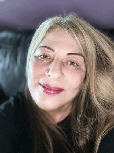 a close up of a woman 's face with a black shirt on