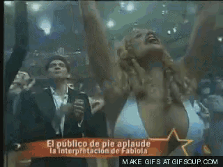 a man and a woman are dancing in front of a sign that says " el publico de pie aplaude "