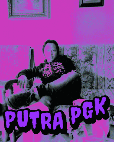 a man sitting on a couch with purple letters that say putra pck