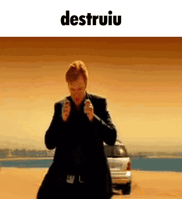 a man in a suit is holding two guns and the word destruiu is on the bottom