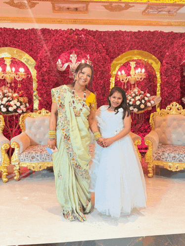 a woman and a little girl pose for a picture