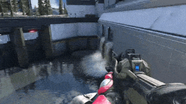 a person is holding a gun in a video game while standing in the water .