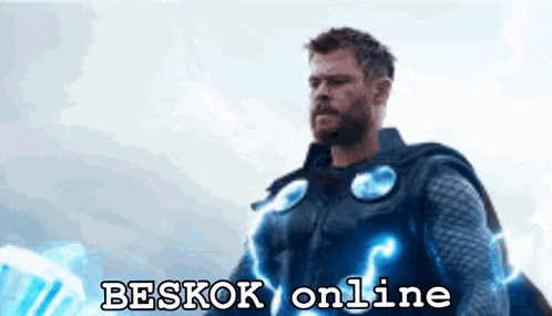 a man in a superhero costume is standing in front of a sign that says " besok online "