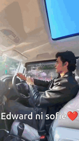 a man is driving a car with the words " edward ni sofie " on the screen