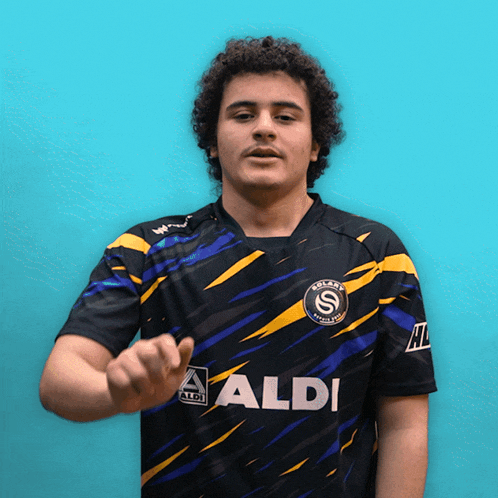 a man wearing a black shirt that says aldi on the front