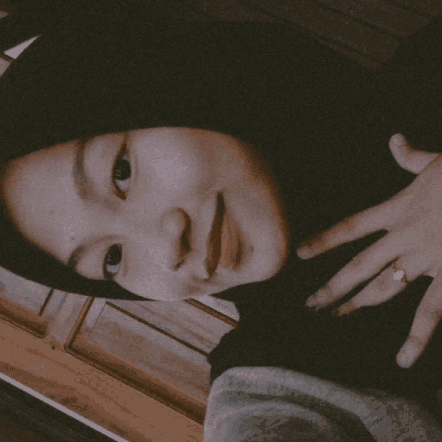 a girl wearing a black hijab and a ring on her finger