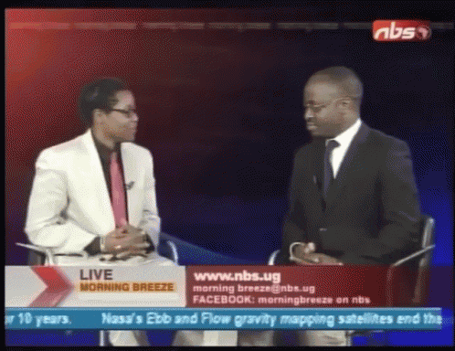 two men are sitting in front of a screen that says ' live morning breeze '