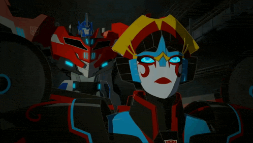 a couple of transformers standing next to each other with one of them having the number 11 on it
