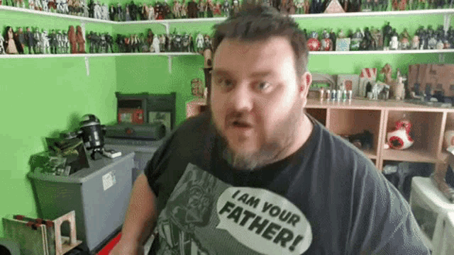 a man with a beard is wearing a shirt that says " i am your father "