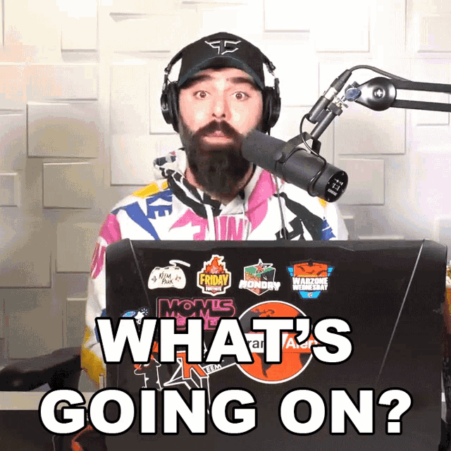 a man wearing headphones stands in front of a microphone with the words what 's going on