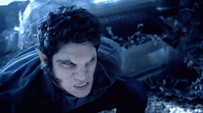 a close up of a werewolf with red eyes looking at the camera