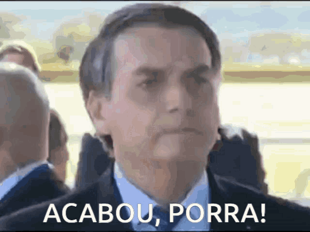 a man in a suit and tie with the words " acabou porra " on the bottom