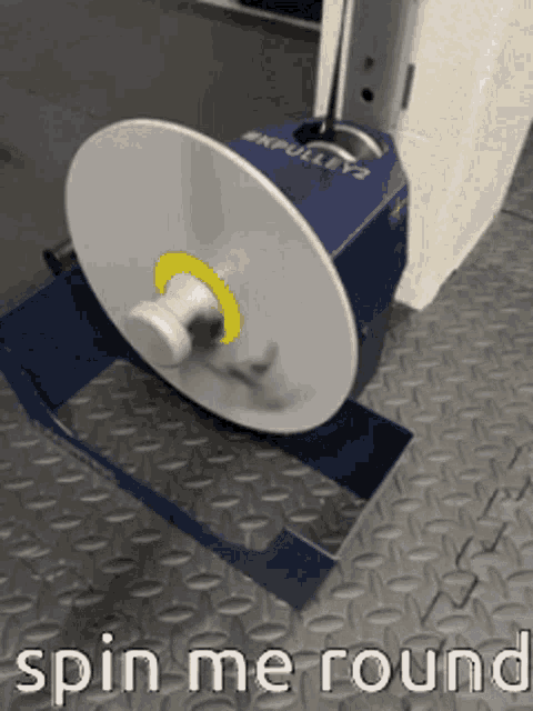a machine that says spin me round is on a metal floor