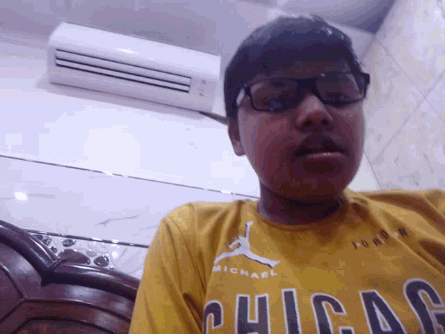 a man wearing a yellow shirt that says chicago