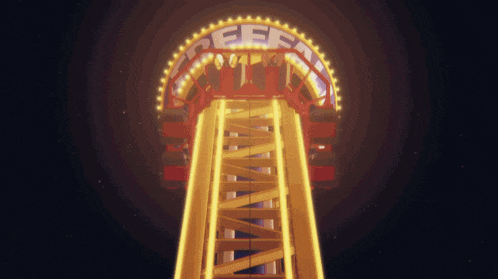 a roller coaster is lit up at night and has the word free on it