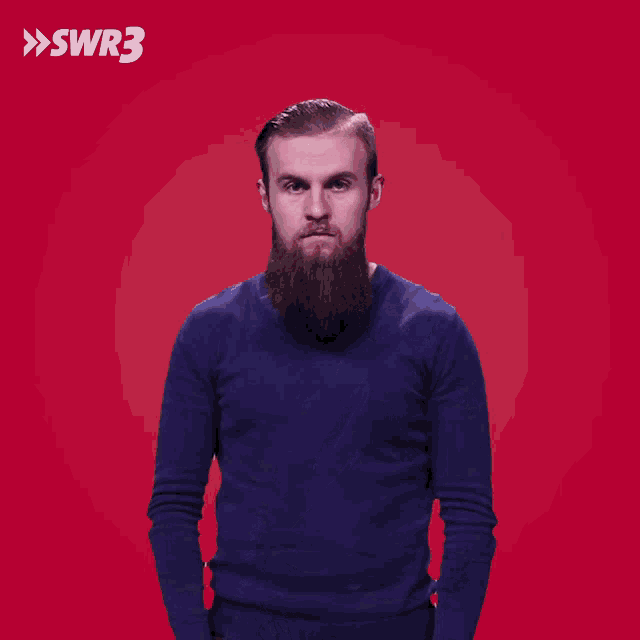 a man with a beard is covering his mouth with his hand in front of a red background with the letters swr3 on it