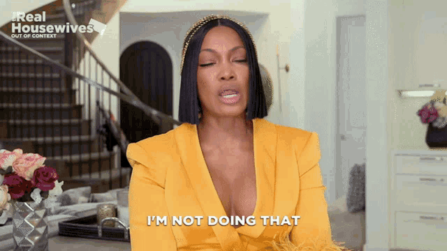 a woman in a yellow blazer says i 'm not doing that