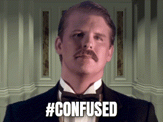 a man in a tuxedo with a mustache is looking at the camera and says `` confused '' .