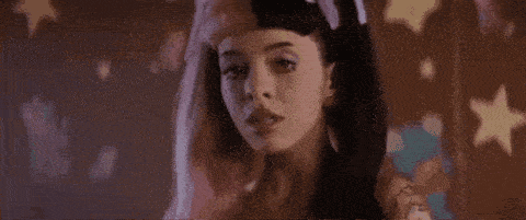a close up of a woman with half pink and half black hair .