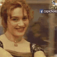a woman is smiling and looking at the camera in front of a facebook logo .
