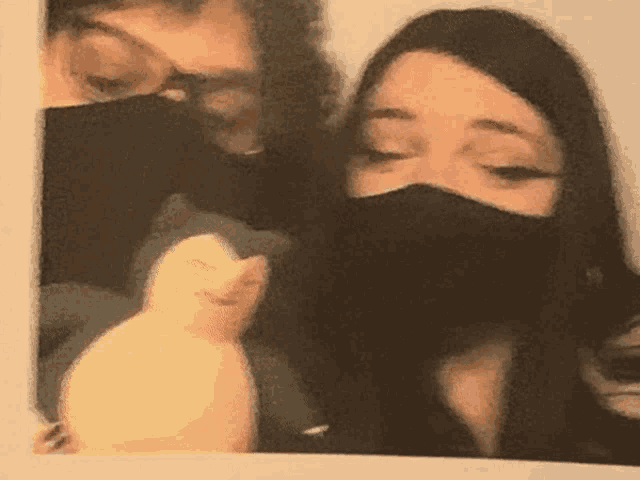 a blurry photo of two people wearing masks
