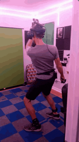 a man wearing a virtual reality headset is standing in a room with a checkered floor .