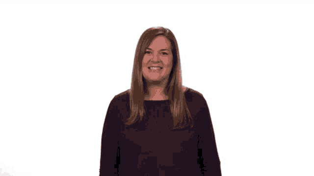 a woman wearing a purple shirt is smiling for the camera