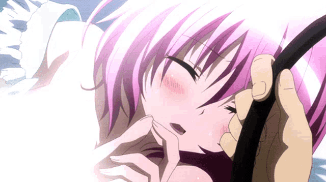 a girl with pink hair is being held by someone