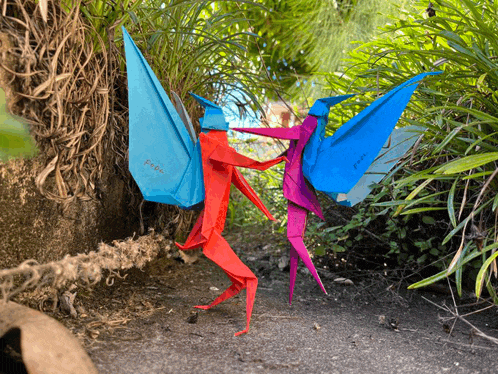 a red and blue origami figure with the word paper on the back