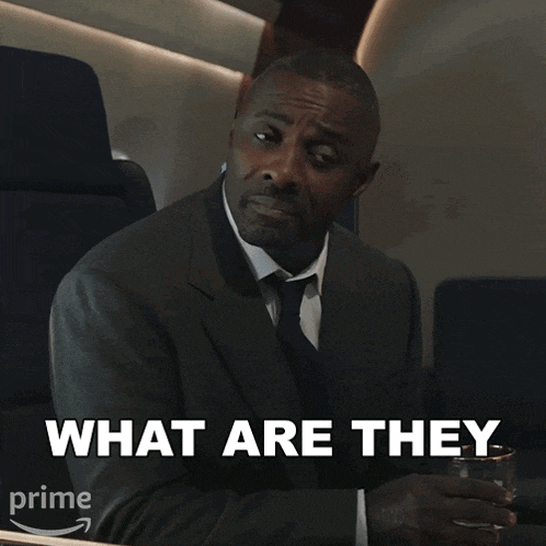 a man in a suit and tie is holding a glass of water and says " what are they "
