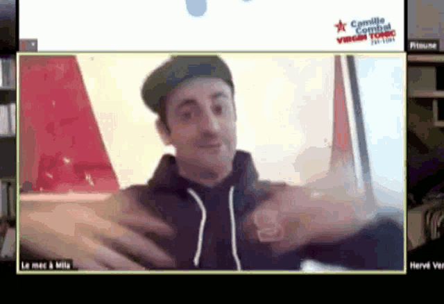 a man wearing a black sweatshirt with the letter s on it is on a video call