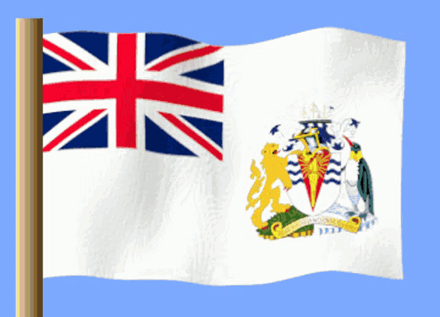 a british flag with a coat of arms on it is waving in the wind
