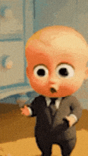 a baby from the boss baby is wearing a suit and tie and standing on a table .