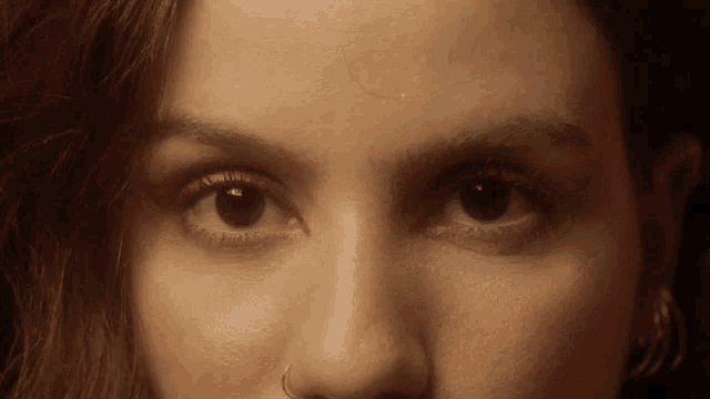 a close up of a woman 's eyes with red eyeliner