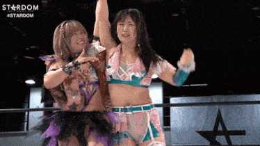 two women in a wrestling ring with the word stardom on the bottom right
