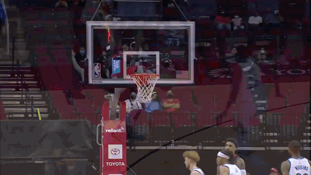 a basketball game is being played on a court that has toyota written on it