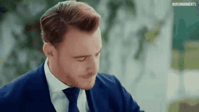 a close up of a man in a suit and tie .