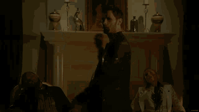 a man with blood on his face is standing in front of a fireplace
