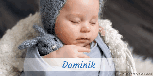 a baby is wrapped in a blue blanket and the name dominik is on the bottom