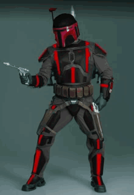 a man in a black and red armor holds a gun