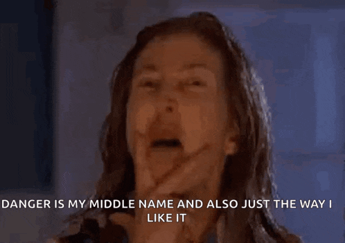 a woman is making a funny face with the words danger is my middle name and also just the way i like it .