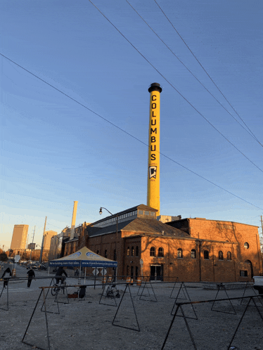 a brick building with a yellow tower that says columbus
