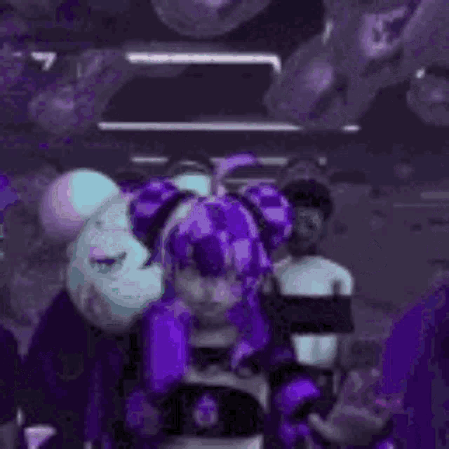 a girl with purple hair is standing next to a teddy bear in a room .