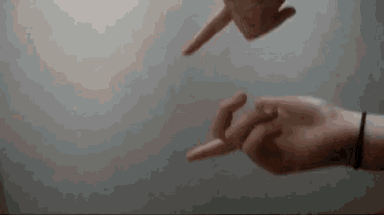 a person is pointing at another person 's finger with their hands .