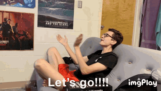 a man sitting on a couch with the words let 's go on the bottom right