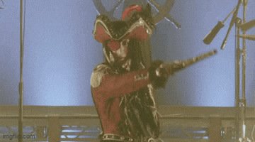 a person in a costume is standing in front of a microphone in a room .