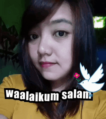 a woman in a yellow shirt is taking a selfie with a dove and the words waalaikum salam
