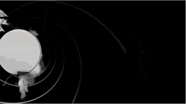 a man in a suit and tie is looking through the barrel of a bullet .