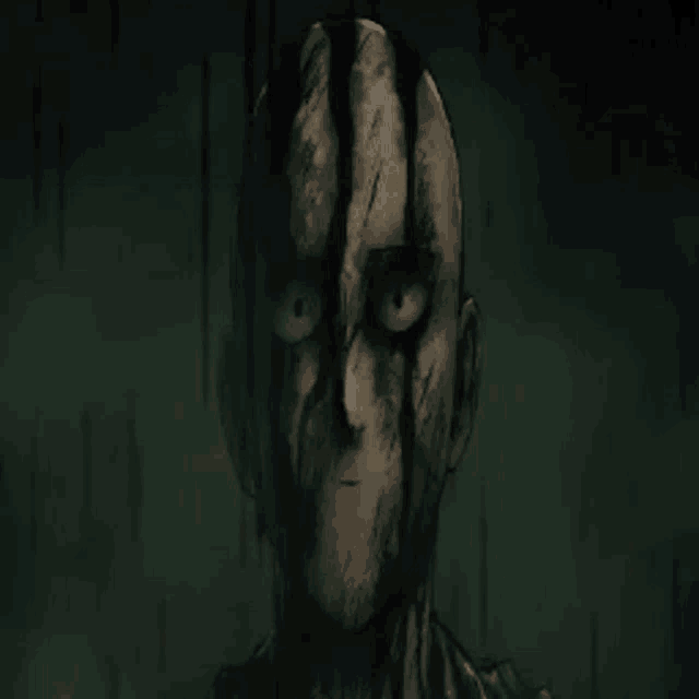 a close up of a man 's face with a very scary look on it .