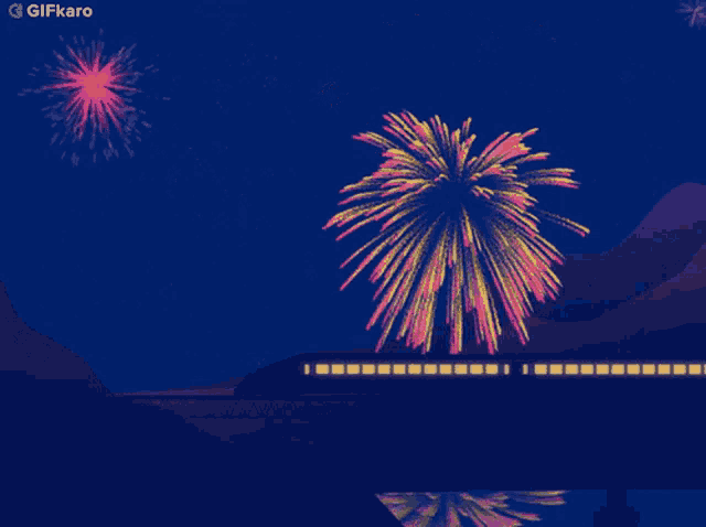 a train is going over a bridge with fireworks behind it